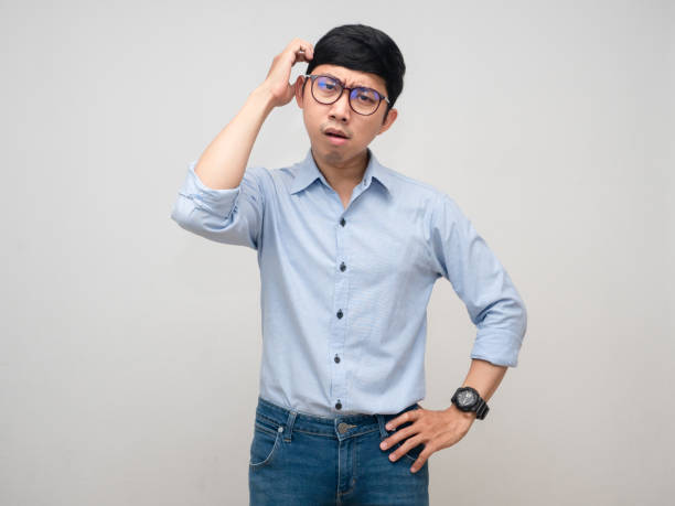 istock Young businessman feels confused gesture scratch his head isolated 1429836844