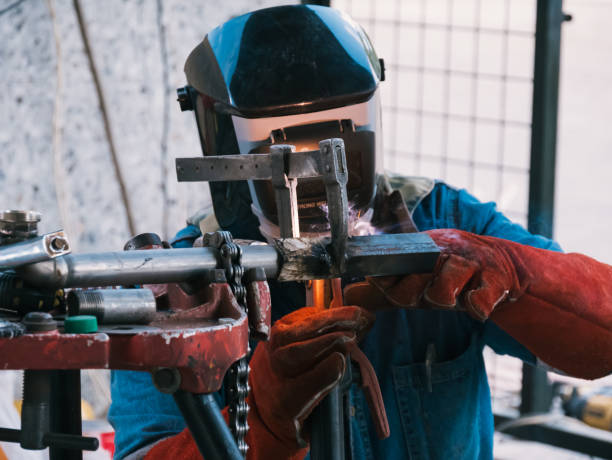 istock Iron soldering, Man working on iron soldering, welding sparks 1429838732