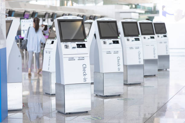 a self check-in counter at the airport - self service stockfoto's en -beelden