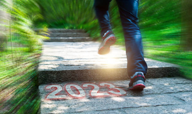 istock Man running on forest stairs with new year number 2023 1429860188