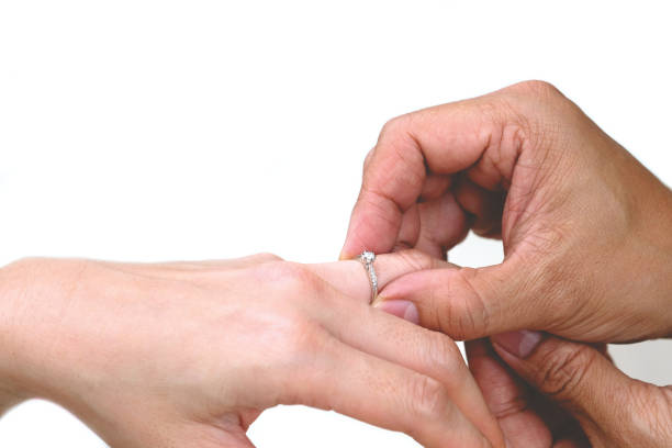 istock Man wearing wedding ring to woman. 1429860424