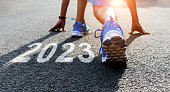 istock Young sports man preparing to run with new year number 2023 on the road 1429860515