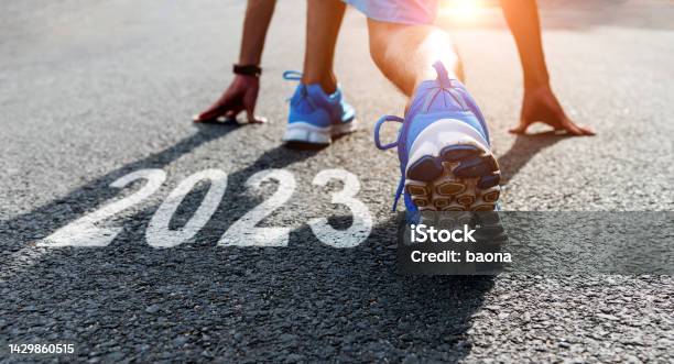 Young Sports Man Preparing To Run With New Year Number 2023 On The Road Stock Photo - Download Image Now