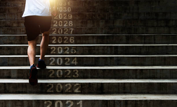hombre corriendo por las escaleras al aire libre con el número de año nuevo 2022, 2023, 2024 a 2031 - staircase running moving up jogging fotografías e imágenes de stock