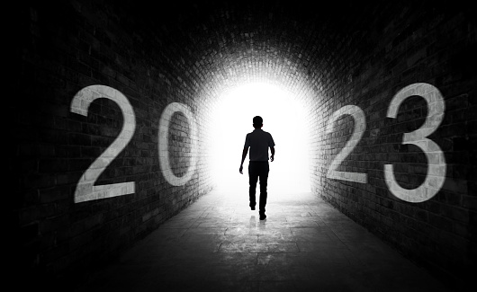 Rear view of man walking into new year 2023
