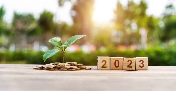 istock Coin jar and new year number 2023 on the table 1429861235