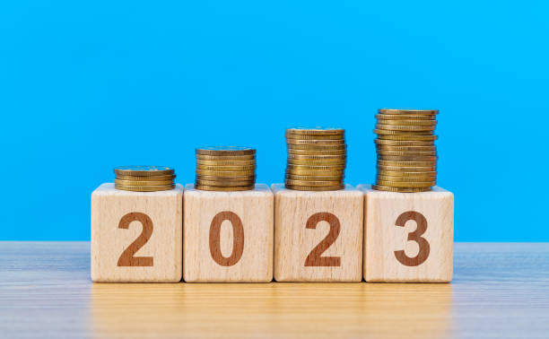 istock 2023 wooden numbers with coins on the table 1429861500