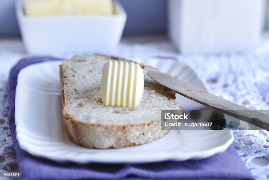 Bread and butter with a wooden knife for breakfast Bread and butter swirl with a wooden knife for breakfast Butter Stock Photo