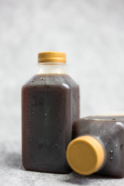 Ready-to-drink black coffee beverages packed in plastic bottles. Close up
