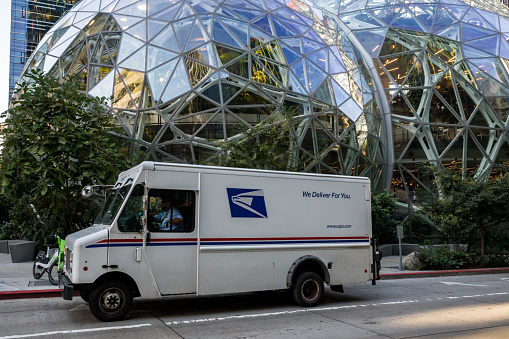 Seattle, USA - Sep 30, 2022: Late in the day a USPS delivery van by the Amazon HQ.