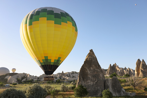 Colorful hot air balloon flying over Cappadocia Turkey. Cave towns of Cappadocia