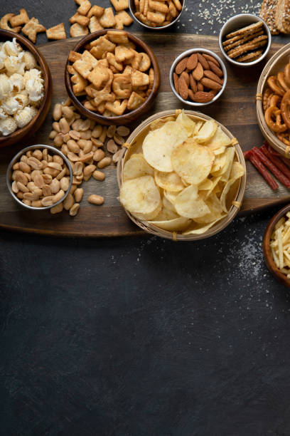 istock Assortment of salty snacks on dark background. 1429889700