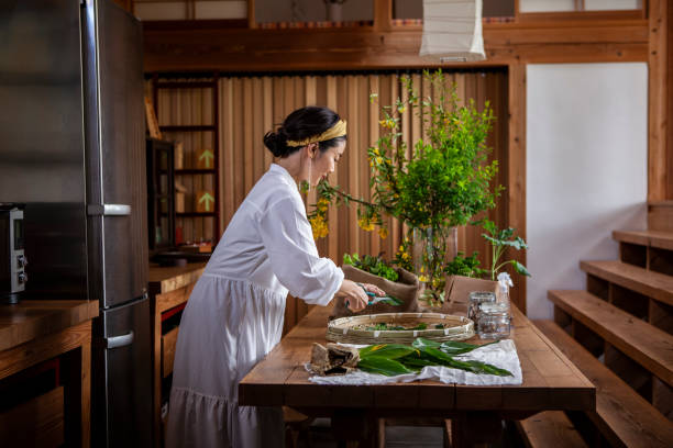 istock A woman cutting herbs and vegetables in the kitchen. 1429889826