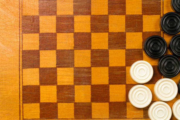 istock Old chessboard made of wood with checkers. 1429891935
