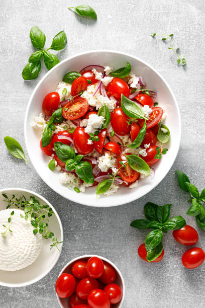 istock Salad with tomato, italian ricotta cheese and basil, top view 1429894375