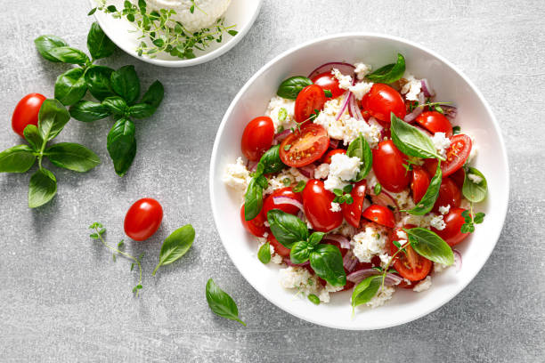 istock Salad with tomato, italian ricotta cheese and basil, top view 1429894376