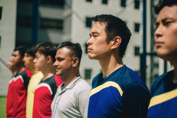 Soccer players standing in row before match