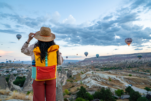 A vibrant hot air balloon gracefully soars over the picturesque Alentejo fields, painting the sky with a burst of color.