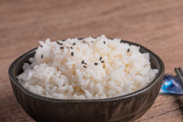 Cooked rice in a cup of black Thai jasmine rice Cooked rice in a cup of black Thai jasmine rice Cup of Jasmine Rice stock pictures, royalty-free photos & images