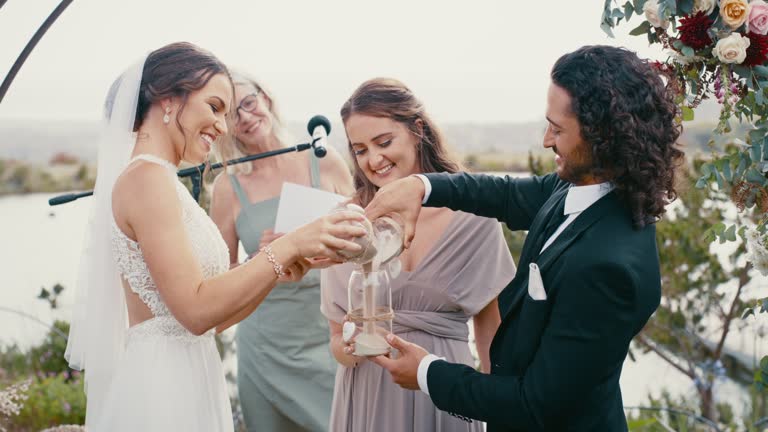 Happy bride and groom wedding with sand and glass tradition at ceremony outdoor as icon of love, relationship and unity. Man and woman at a marriage and commitment event to become husband and wife