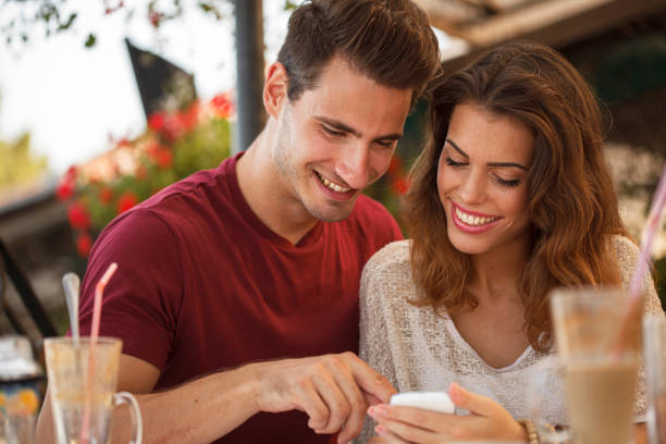 istock Couple using smart phone while waiting for their food at the restaurant 1429903833