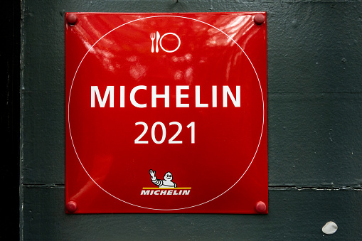 A michelin plaque outside a Michelin star restaurant.