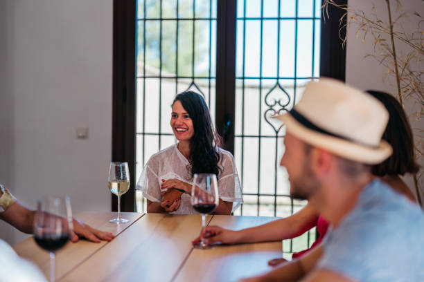 young brunette woman smiles before rolling the dice stock photo