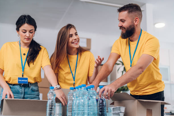 Group of volunteers working in community charity donation center stock photo
