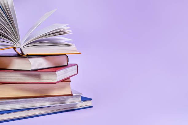 istock Close-up of a stack of books with one open book on top 1429907005
