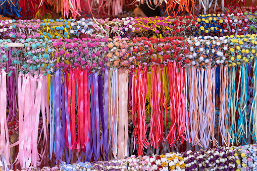 Craft fair with medieval motifs, in a store of colorful tiaras, are crowns with flowers and colorful ribbons to hold women's hair.