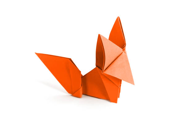 Orange paper fox origami isolated on a blank white background.