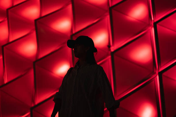istock Lady silhouette on colorful lights background 1429914239