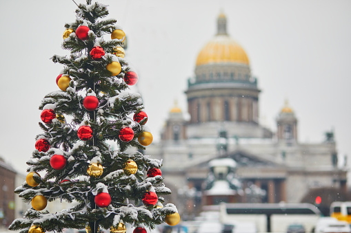 Scenic view of St. Isaac's Cathedral and decorated Christmas tree in Saint Petersburg, Russia, on a beautiful winter day