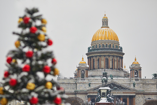 Scenic view of St. Isaac's Cathedral and decorated Christmas tree in Saint Petersburg, Russia, on a beautiful winter day