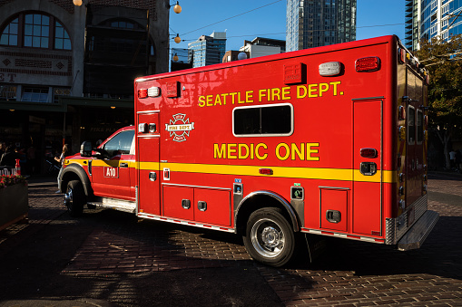Seattle, USA - Sep 30th, 2022: A Seattle Fire Department ambulance late in the day during an emergency at Pike Place Market.