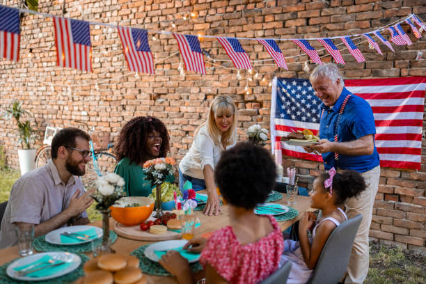 istock Multi-generation family having dinner outdoors on an American national holiday 1429927125