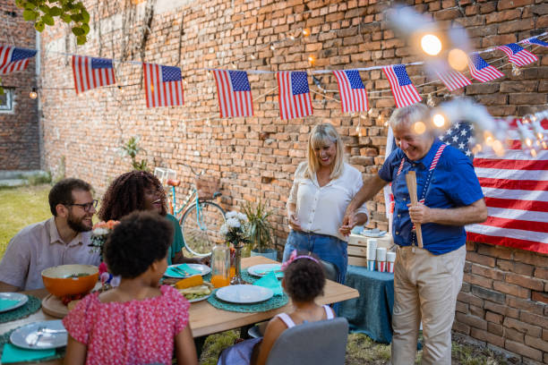 istock Multi-generation family having dinner outdoors on an American national holiday 1429927187
