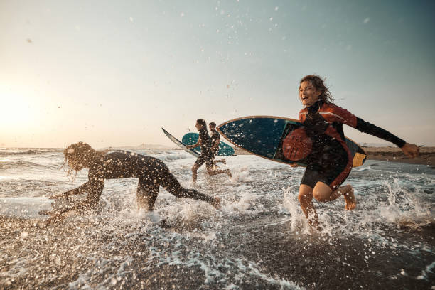 istock Carefree surfers having fun while surfing in sea at sunset. 1429927208