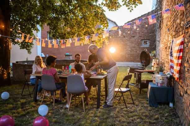 istock Multi-generation family having dinner outdoors on an American national holiday 1429927450