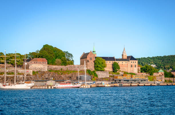 Akersus Fortress in Oslo, Norway, seen from the sea. Oslo, Norway - August 13 2022: Akersus Fortress seen from the sea (Oslofjord) in a summer afternoon østfold stock pictures, royalty-free photos & images