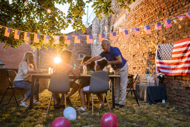 istock Multi-generation family having dinner outdoors on an American national holiday 1429929162