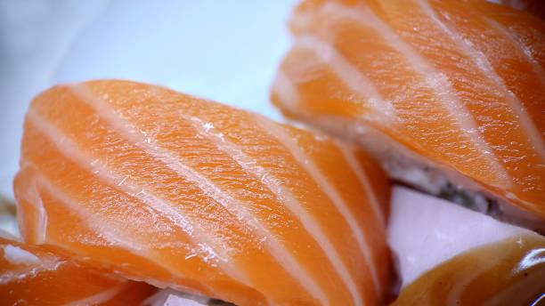 istock Sushi rolls of red fish on a light background 1429929532