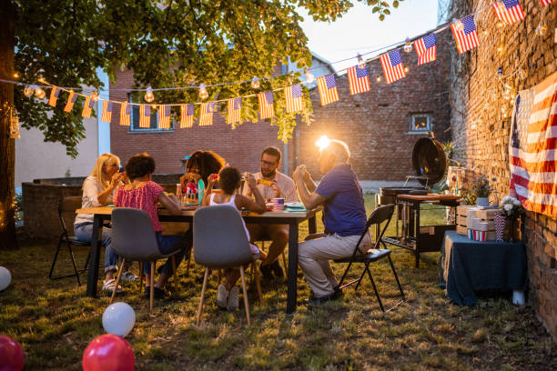 istock Multi-generation family having dinner outdoors on an American national holiday 1429929955
