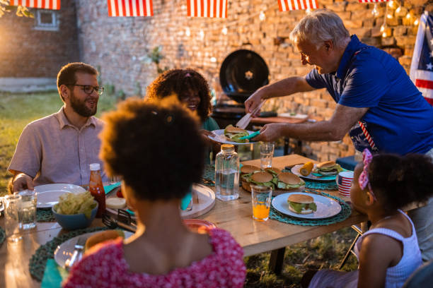 istock Multi-generation family having dinner outdoors on an American national holiday 1429931327