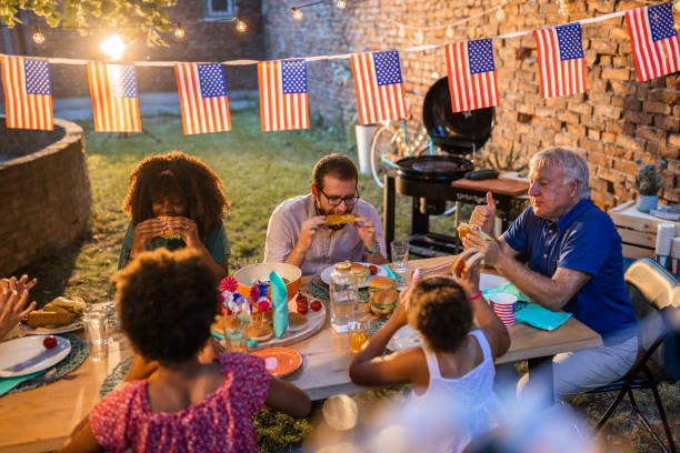 istock Multi-generation family having dinner outdoors on an American national holiday 1429931329
