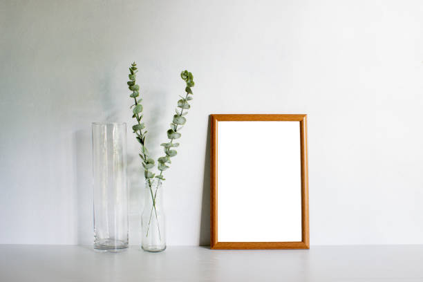 istock A wooden frame and green leaves with natural light. 1429932326