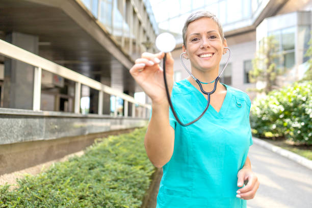 istock Happy nurse holding stethoscope 1429937148