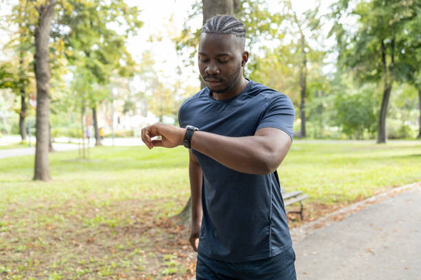 istock Fit man checking time on wristwatch 1429938121