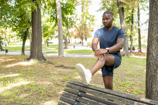 istock Fit man stretching legs on park bench before a run 1429938133