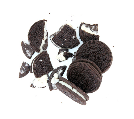 Sandwich chocolate cookies with a sweet cream with crumbs isolated on white background